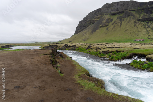 Mountain stream cold water running over rocks and stones. Iceland