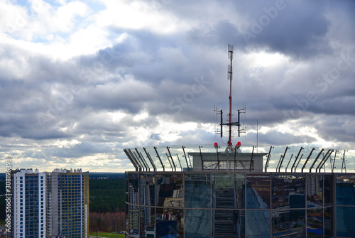 Telecommunication antenna on the roof of a building tower © AliaksandrBS