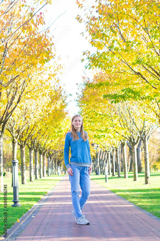 Portrait of young beautiful happy woman, autumn outdoors