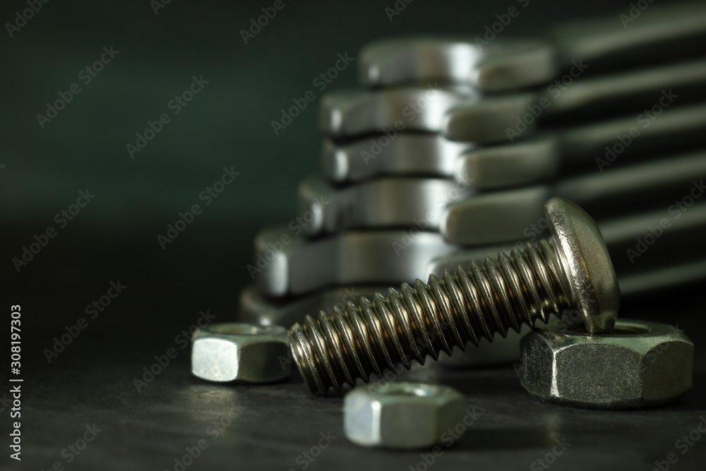 Bolt nuts and wrench on cement floor in darkness. Closeup and copy space for text. Concept of mechanical engineering jobs. Bolt nuts and wrench on cement floor in darkness. Closeup and copy space for text. Concept of mechanical engineering jobs.