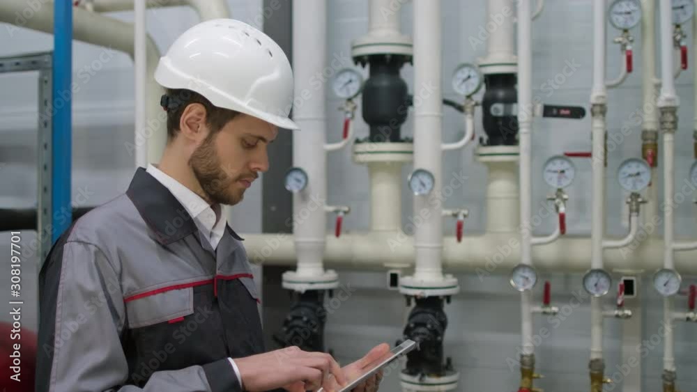 worker engineer man working tablet on tubing of pump system at offshore oil gas industry platform pipeline, Service business of petroleum industry. gas oil production station. Engineering. slow-mo 4 K worker engineer man working tablet on tubing of pump system at offshore oil gas industry platform pipeline, Service business of petroleum industry. gas oil production station. Engineering. slow-mo 4 K