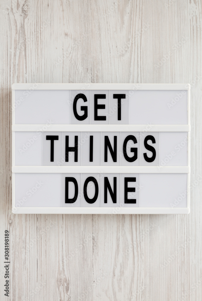 'Get things done' words on a lightbox on a white wooden surface, top view. Overhead, from above, flat lay. 'Get things done' words on a lightbox on a white wooden surface, top view. Overhead, from above, flat lay.