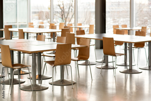 Interior of empty canteen with tables and chairs photo