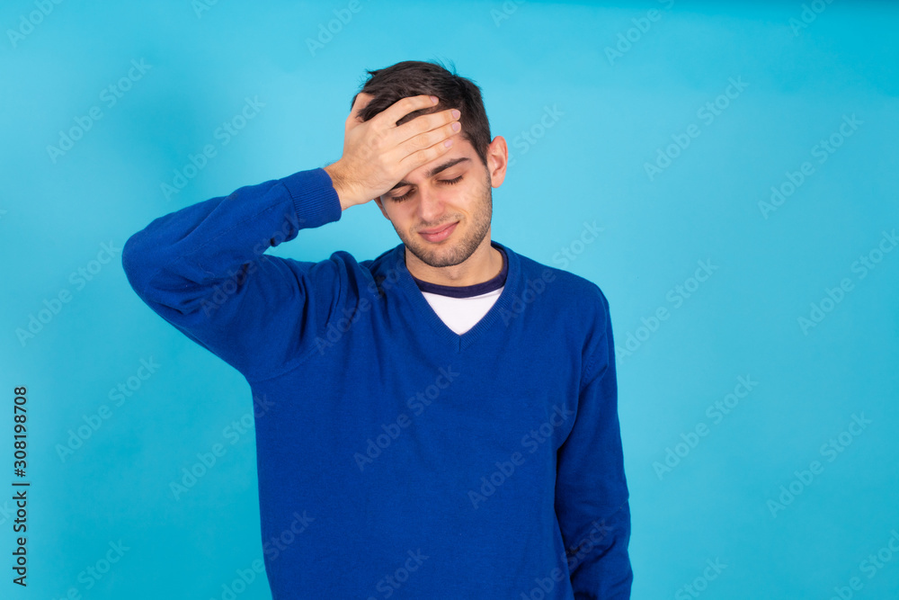 casual young man isolated on natural blue background