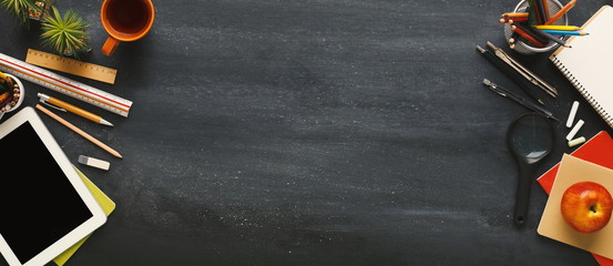 Supplies for school border on black chalkboard, panorama