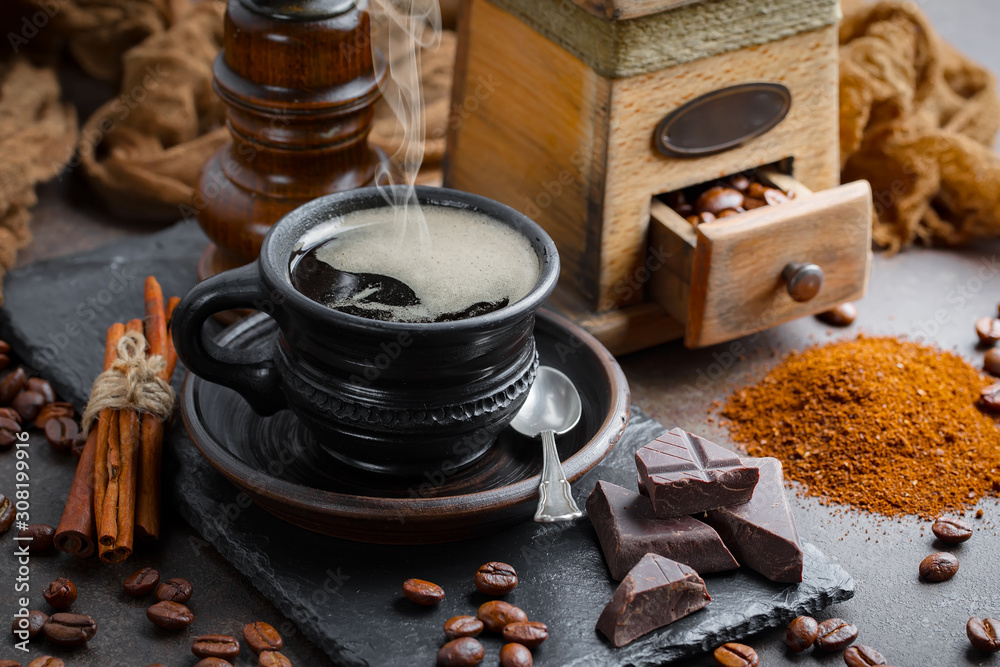 Coffee in a cup on a background of coffee beans, on an old background.