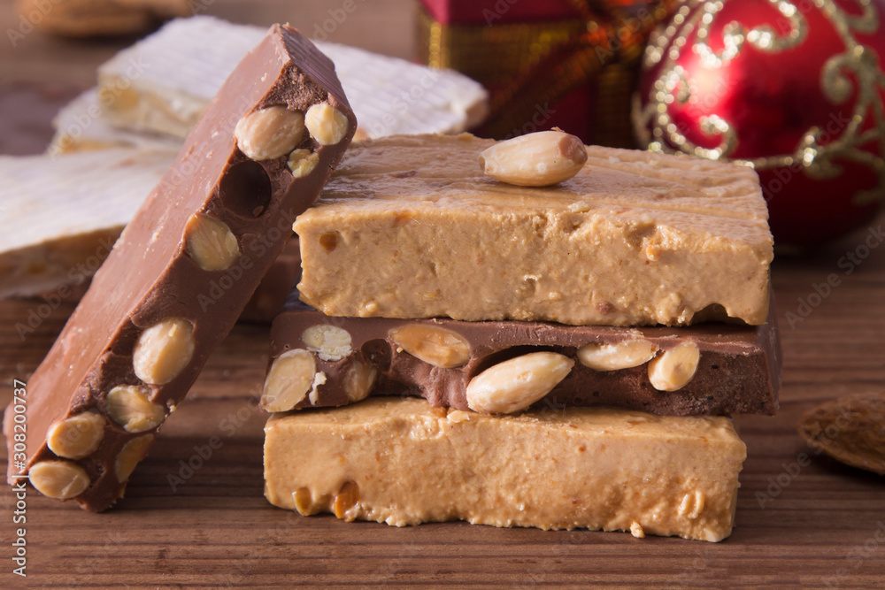 nougat, typical Christmas dessert on wooden background nougat, typical Christmas dessert on wooden background
