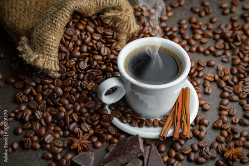 Coffee in a cup and saucer on an old background.