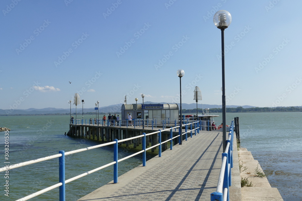Naklejka premium pier for ferries to Maggiore Island and Polvese Island in the lakeside of Castiglione del Lago on Trasimeno Lake.