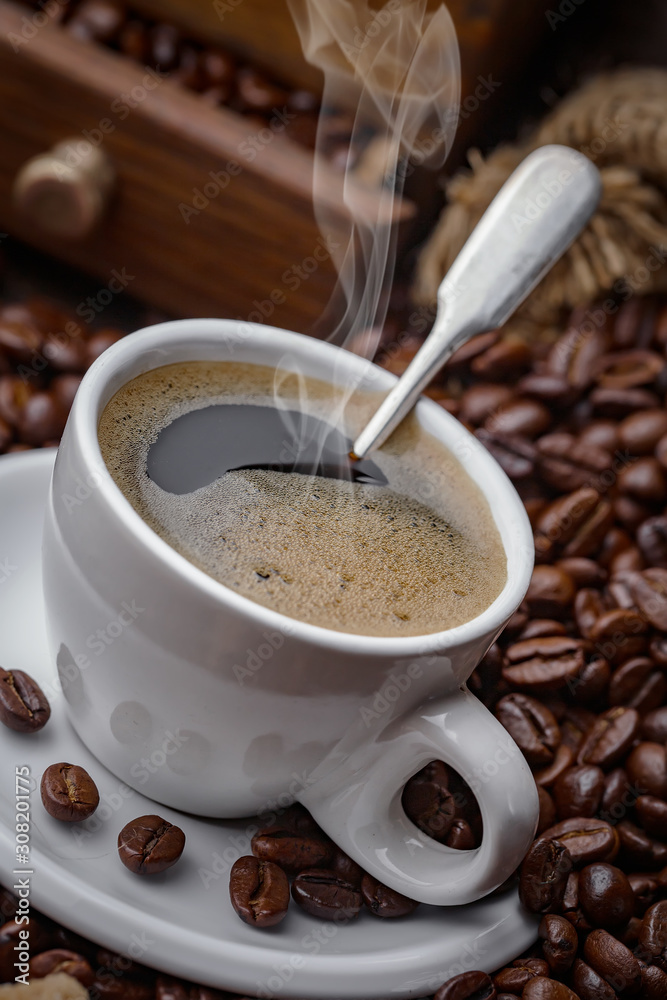 Coffee in a cup and saucer on an old background. Coffee in a cup and saucer on an old background.