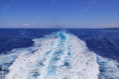 Trail of surging water from a sailing ship. Boat wake on the sea.. © MagioreStockStudio