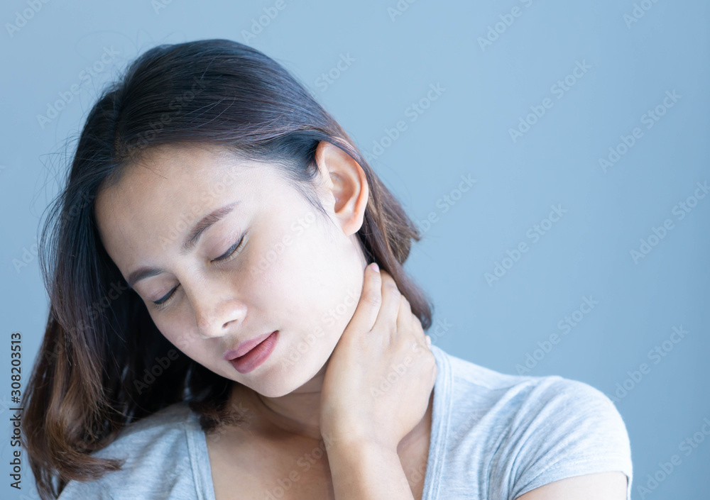 Closeup woman holding neck with pain after waking up on bed, healthy care and medical concept Closeup woman holding neck with pain after waking up on bed, healthy care and medical concept