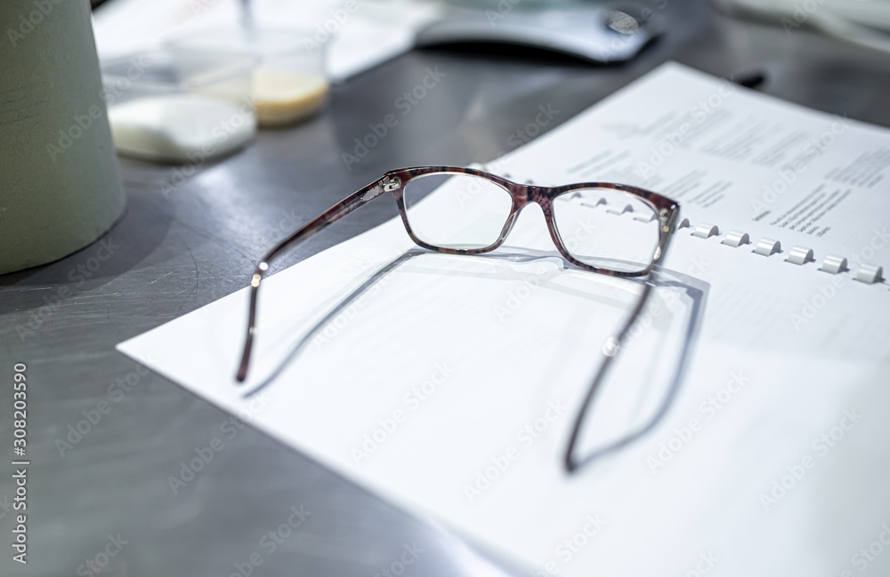 Glasses with documents on the table of business people.