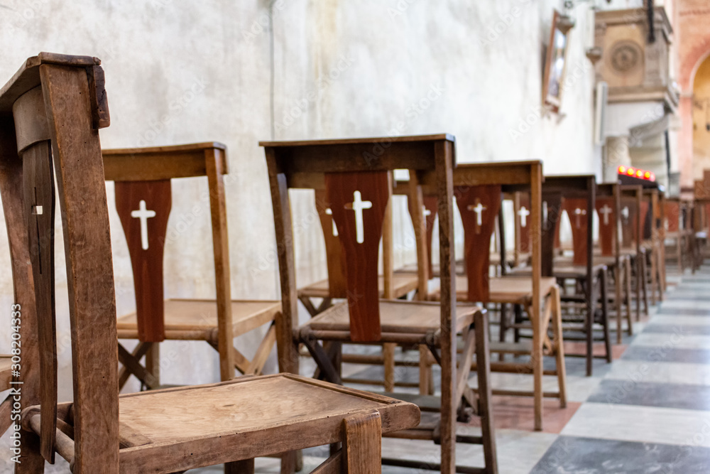 empty wooden chairs in the church during the service