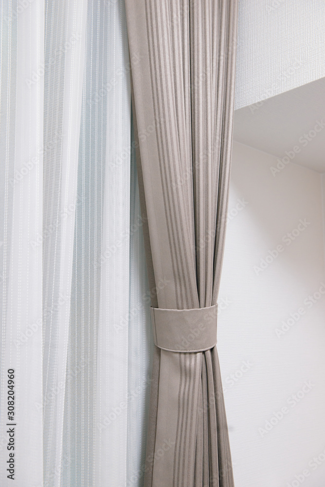 White and brown curtains with ring-top rail, Curtain interior decoration in living room.