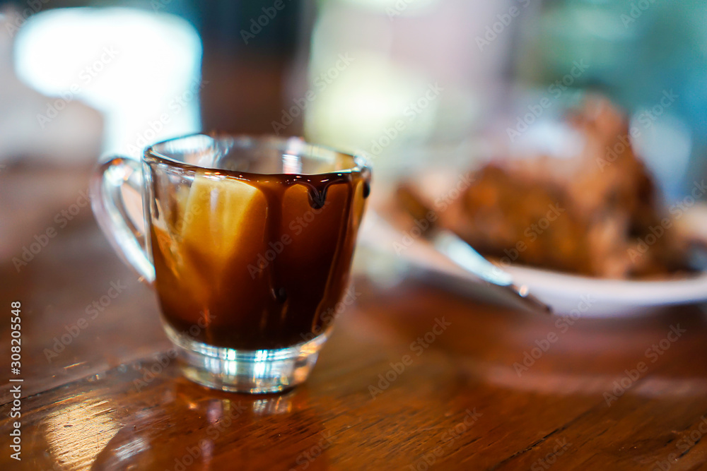 chocolate glass is on the brown wooden table chocolate glass is on the brown wooden table