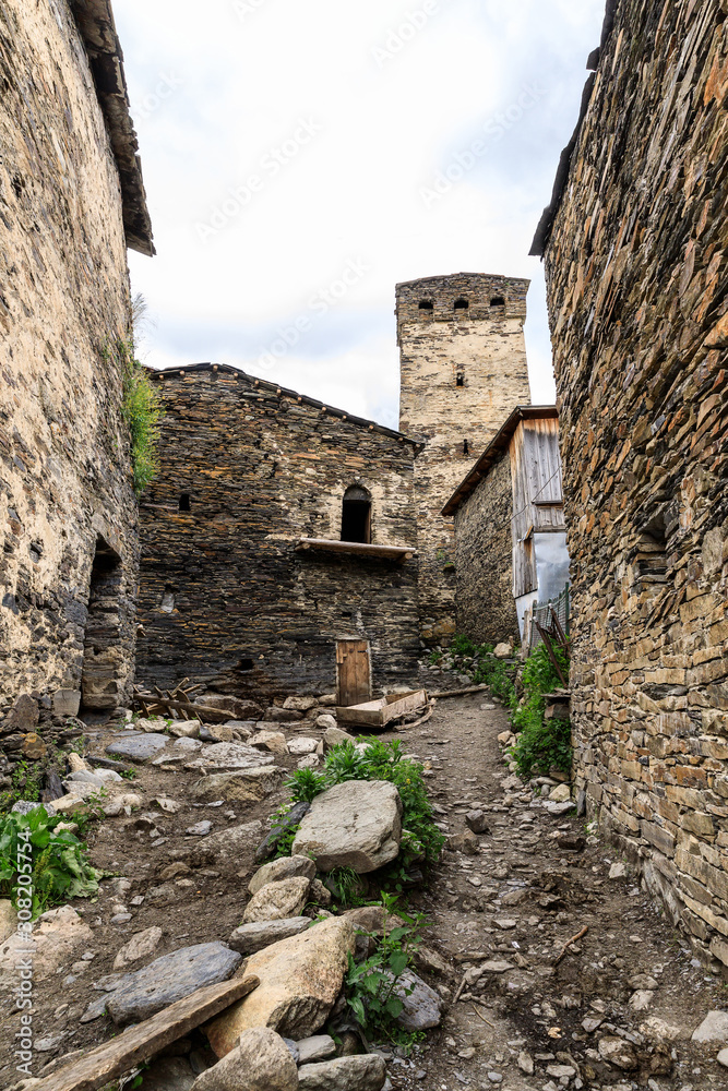 View of the Ushguli village at the foot of Mt. Shkhara. Picturesque and gorgeous scene. Rock tower towers and old houses in Ushguli
