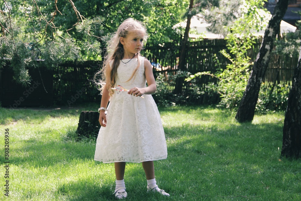 Portrait of little caucasian girl wearing white princess dress for celebration event