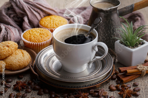 Coffee in a cup on a background of coffee beans, on an old background.