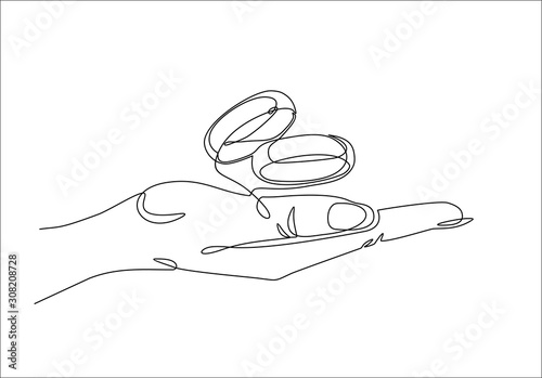 One continuous line drawing of hand holding Wedding rings. Vector illustration. 