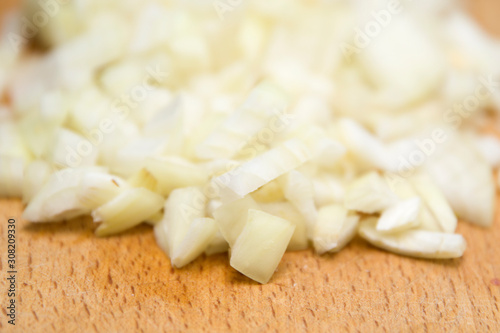 Chopped onions on wooden cu...