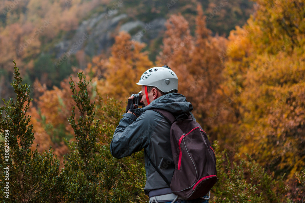 A man with camera shooting landscape in mountain