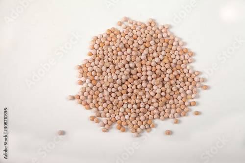 dried yellow raw peas scattered on a white background. Copy spaes.