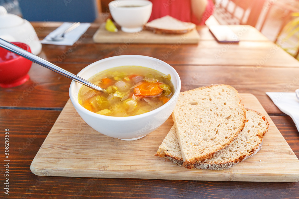 Eating vegetarian soup in outdoor cafe Eating vegetarian soup in outdoor cafe