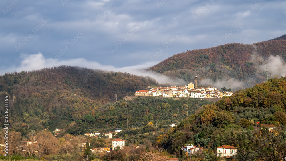 Caprigliola near Aulla, Massa Carrara, Italy, medieval hilltop village in autumn mist. Rolling hills of Lunigiana.