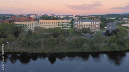 Aerial: Man rowing on the Charles River at Harvard University. Boston, Massachusetts, USA. 28 August 2019