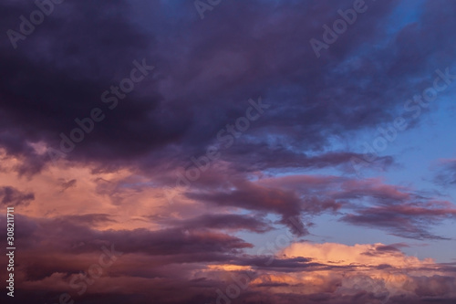 Dramatic sunrise, sunset pink violet storm sky with clouds background texture