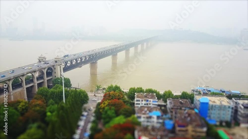 day time wuhan city traffic changjiang bridge living block aerial top view 4k tilt shift china photo