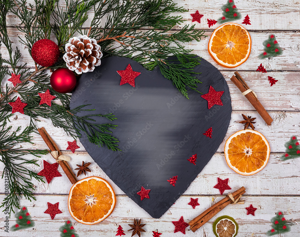 A dark cheese platter with copy space for text in Christmas decor with Christmas tree, dry orange over old table. Rustic style. Flat lay A dark cheese platter with copy space for text in Christmas decor with Christmas tree, dry orange over old table. Rustic style. Flat lay