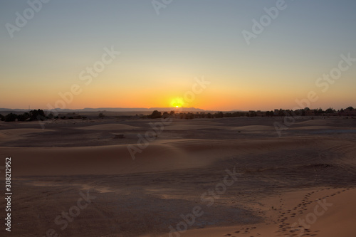 Last sickle of the setting sun above the mountains seen from Erg Chebbi