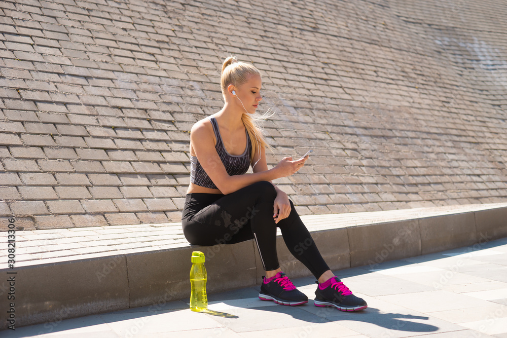 Fototapeta premium Attractive woman in sportswear training outdoor. Sport, jogging, healthy and active lifestyle.