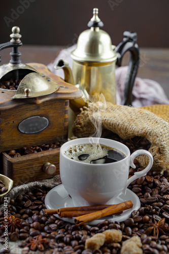 Coffee in a cup and saucer on an old background.