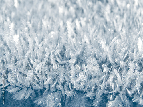 winter background with snowflakes crystals patterns and snow on frozen grass