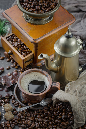 Coffee in a cup on a background of coffee beans, on an old background.