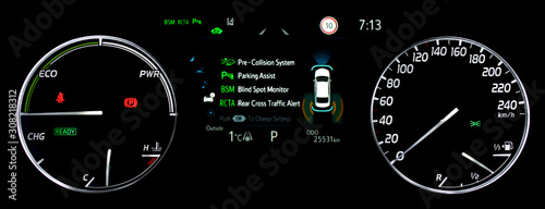 Illuminated car dashboard panel with speedometer, power meter, odometer, fuel and temperature gauge. Modern car display showing advanced driver assistance systems. Car counter in hybrid car. photo