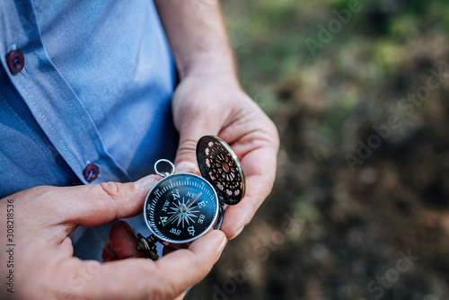 Fényképezés finding our way in nature with a compass, looking for the right direction