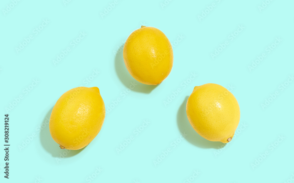 Fresh lemons isolated on bright blue background Fresh lemons isolated on bright blue background