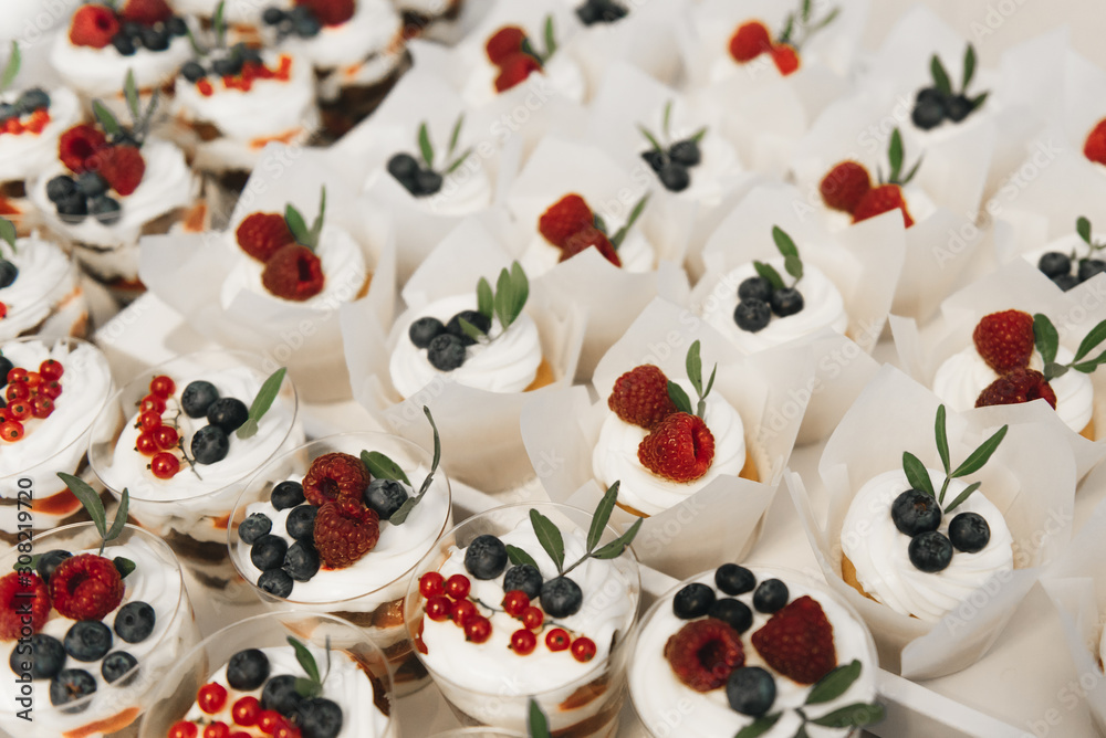 Candy bar. Cupcakes and desserts with berries. The concept of children's birthday parties and weddings Candy bar. Cupcakes and desserts with berries. The concept of children's birthday parties and weddings