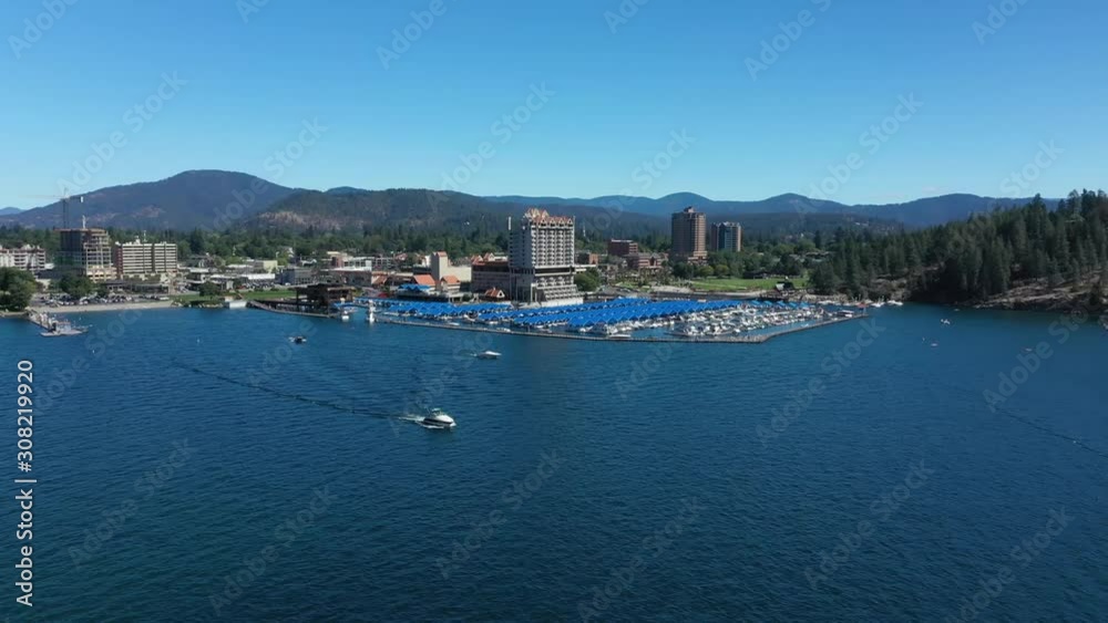 An aerial drone view panning around the Coeur d'Alene resort and marina with boats on the lake. An aerial drone view panning around the Coeur d'Alene resort and marina with boats on the lake.