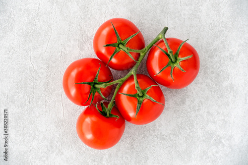 Top view of Tomatoes on the Vine on Gray Textured Background
