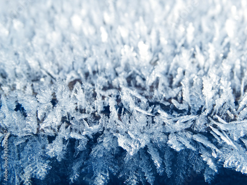 winter background with snowflakes crystals patterns and snow on frozen grass