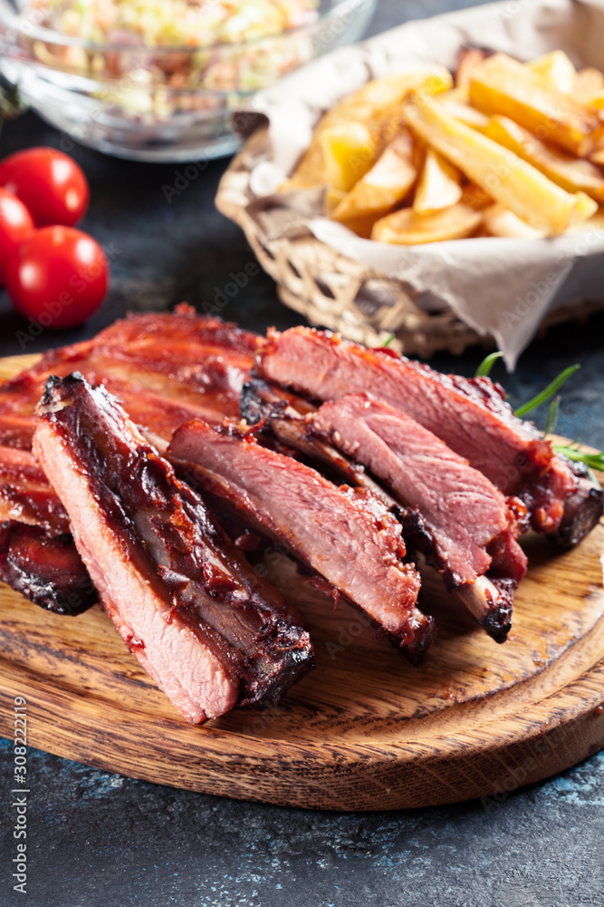 Spicy barbecued pork ribs served with BBQ sauce