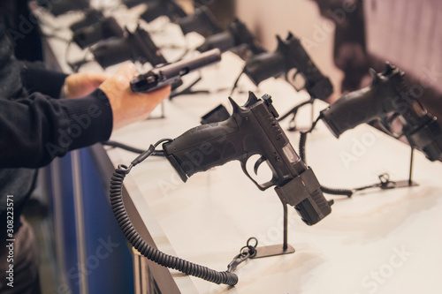 Gun in his hand. Exhibition and sale of weapons