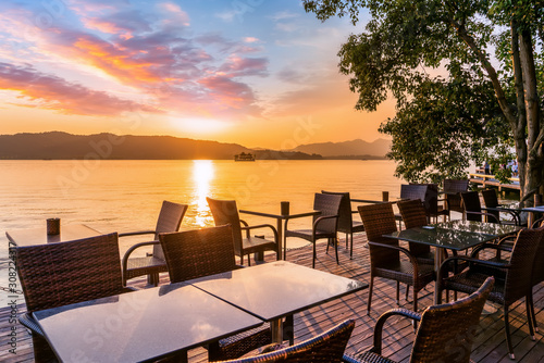 Hangzhou West Lake sunset and outdoor leisure tables and chairs..