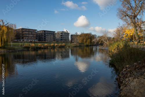 Buildings next to the river on a beautiful day.