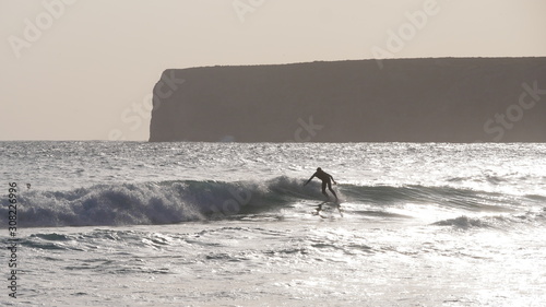 Surfer is riding a big wave in Portugal in the atlantic ocean